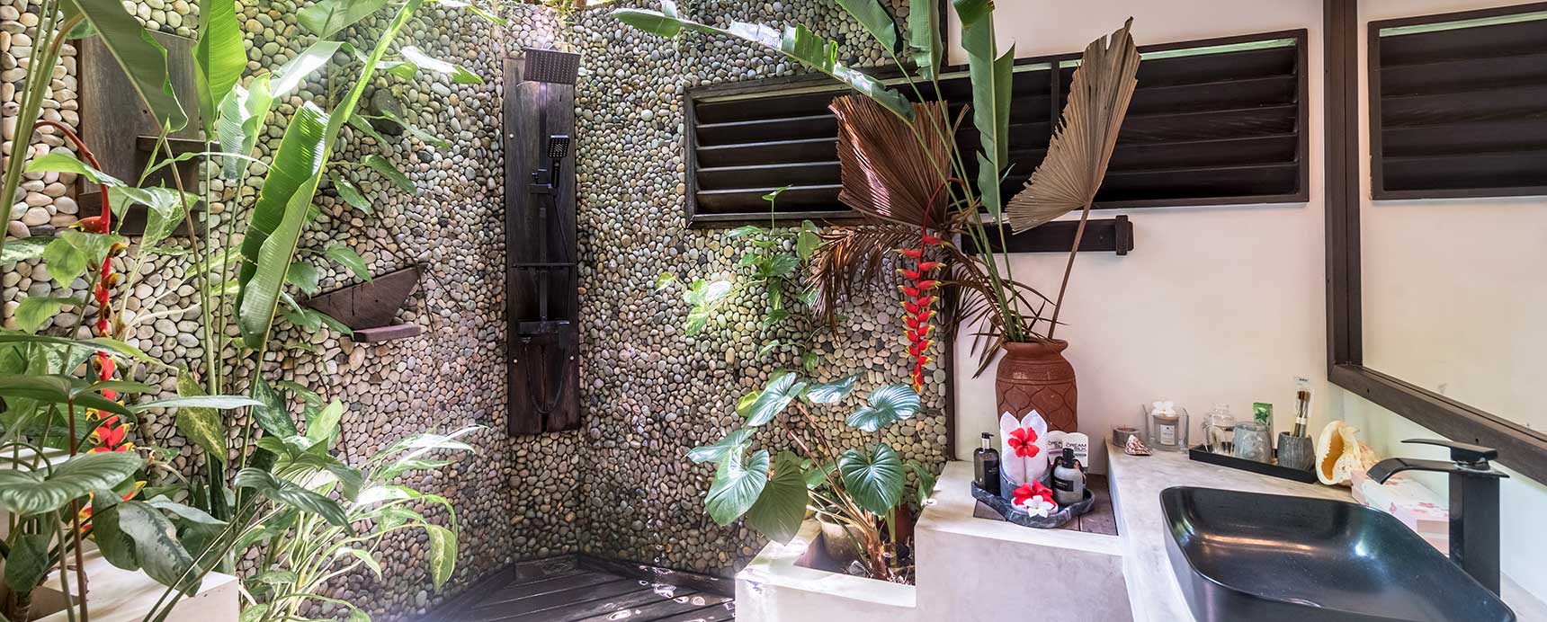 Open-sky outdoor bathroom with pebble-stone shower — private villa bedroom, Kawayan Villa Siargao