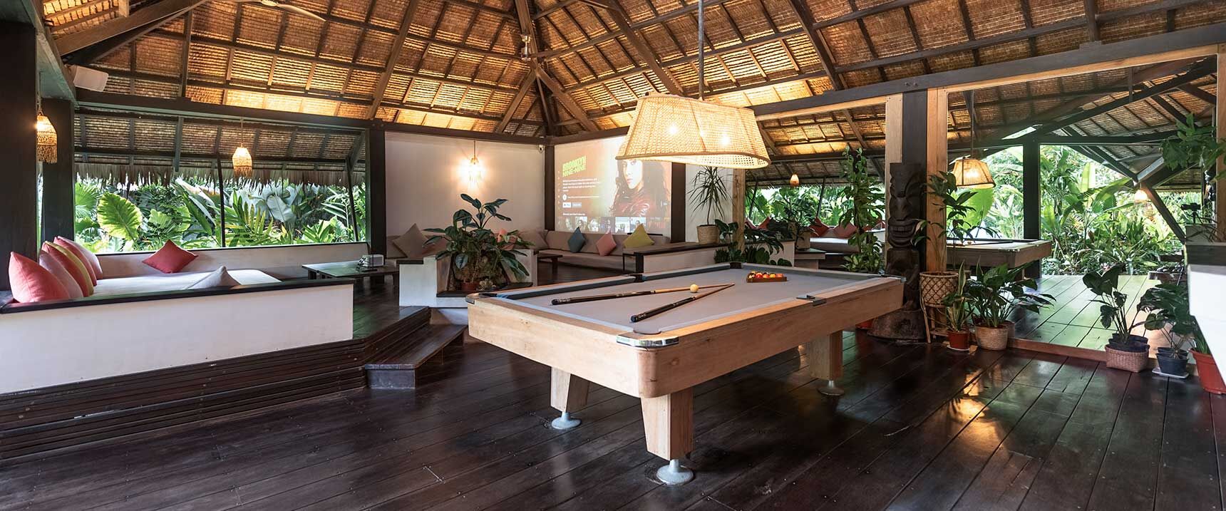 Pool table and private bar in the 220m² living room — group surf trips Siargao at Kawayan Villa