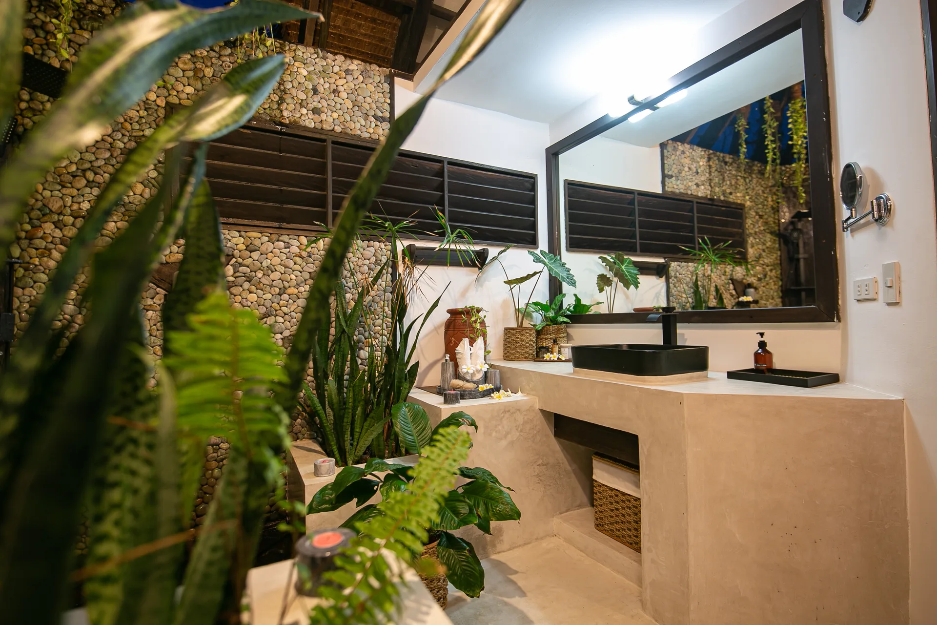 Bathroom vanity with black stone sink and mirror under open sky — Kawayan Villa Siargao
