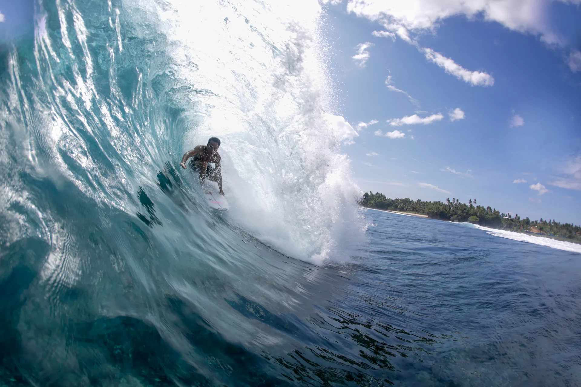 Surfer riding the Cloud 9 reef break, Siargao Island