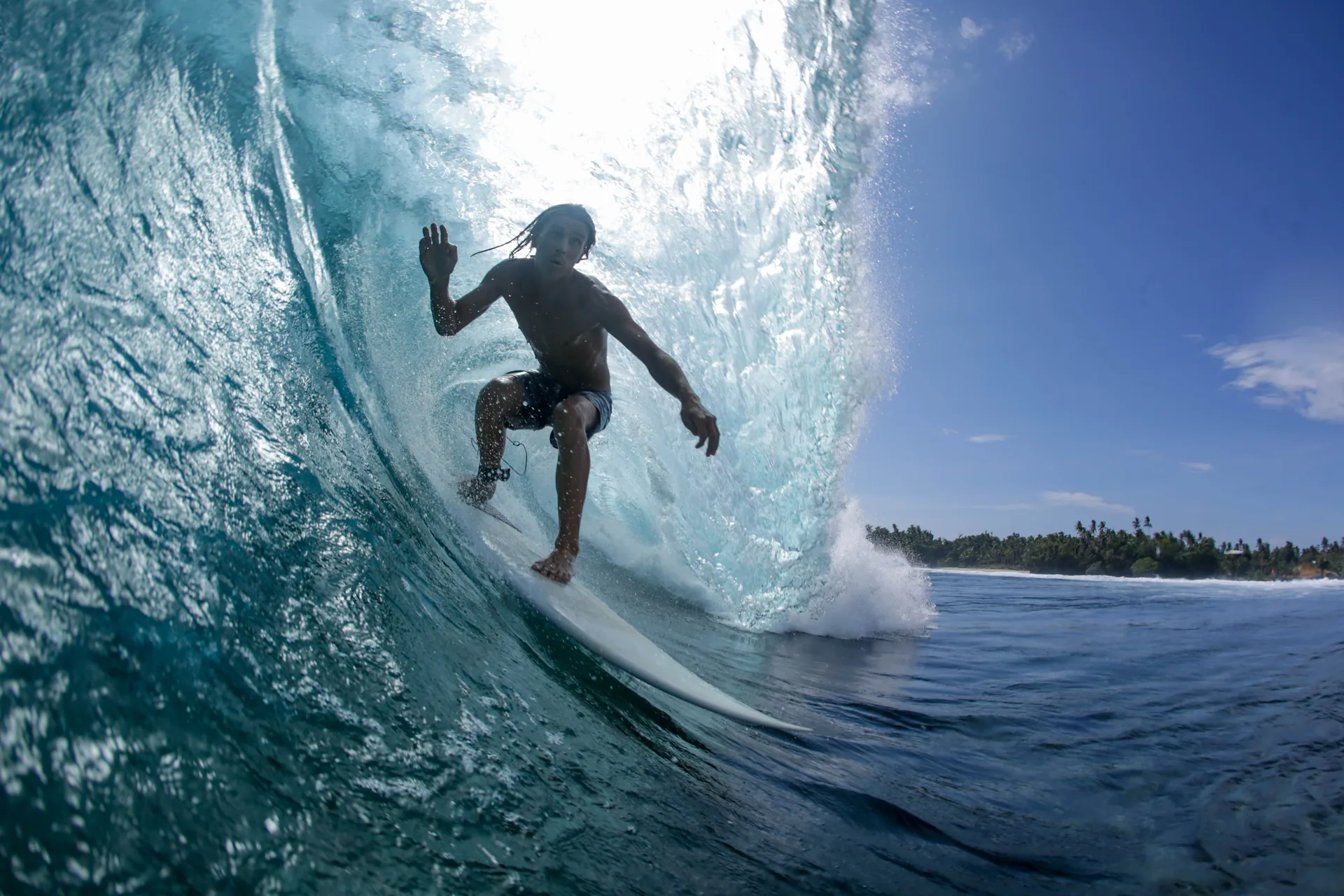 Surfer pulling into a Cloud 9 barrel, Siargao — the wave that hosts the Surfing Cup