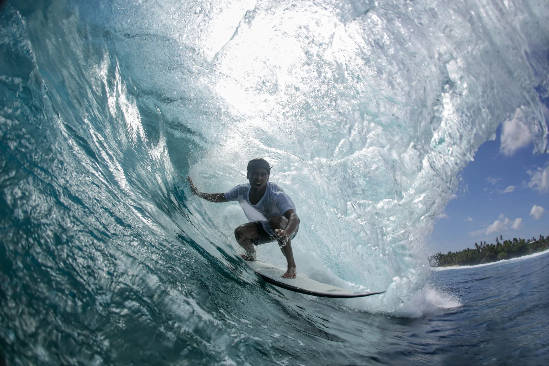 Surfer dropping into a wave at Cloud 9, Siargao