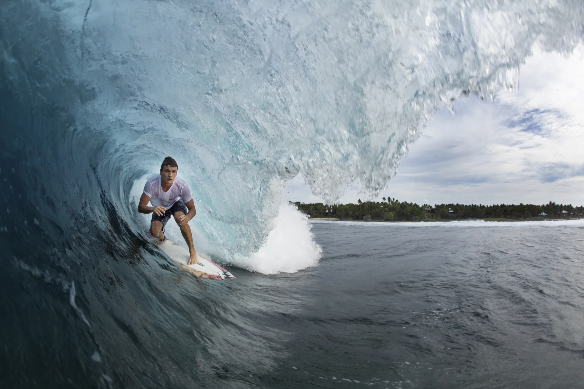 Surfer in a turquoise Cloud 9 barrel, Siargao