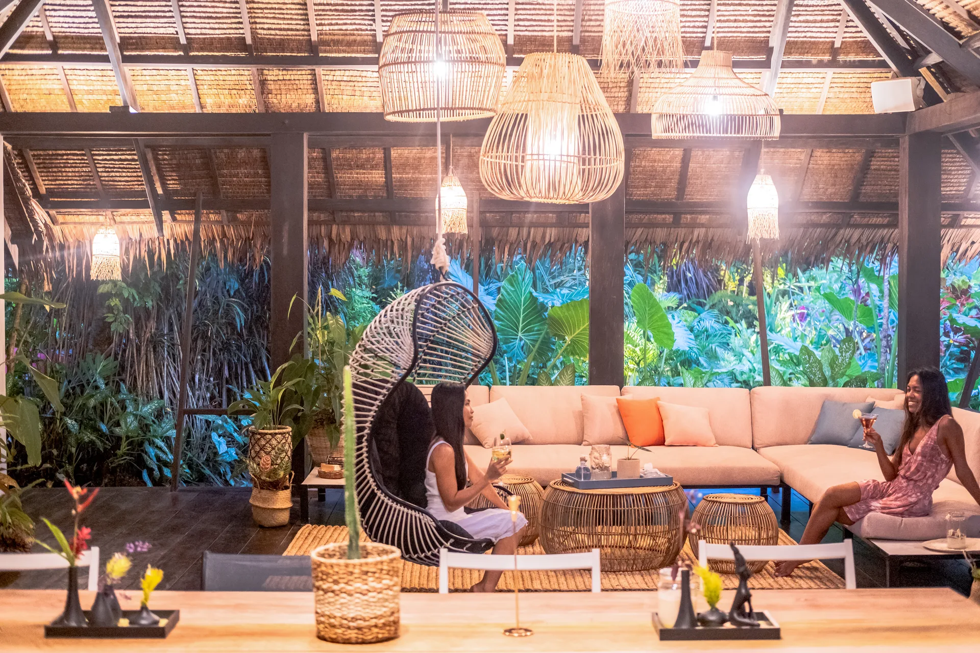 Private outdoor lounge at Kawayan Villa Siargao with peacock chair and tropical garden — quiet retreat from the Cloud 9 boardwalk