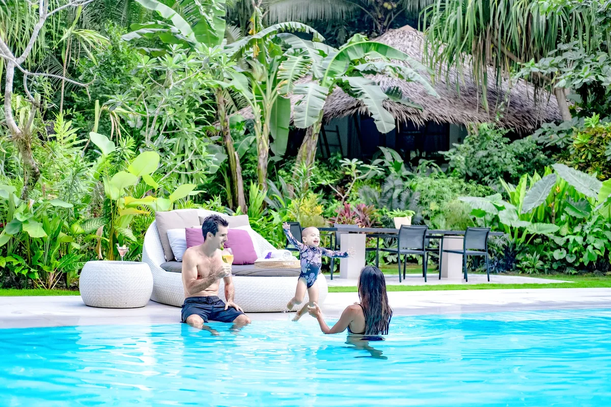 Family of three playing in the private pool at Kawayan Villa Siargao during the dry season